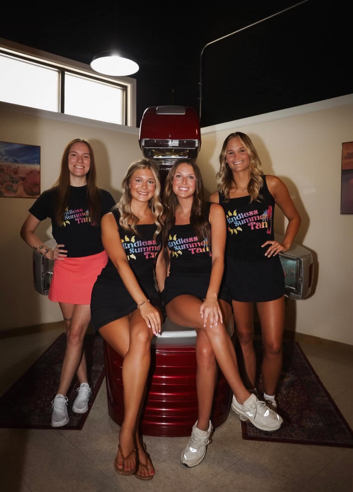 The Endless Summer Tan team by a tanning bed